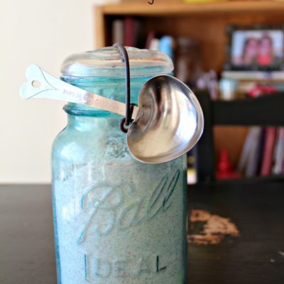 homemade dishwasher detergent in a vintage teal mason jar with heart shaped tbs