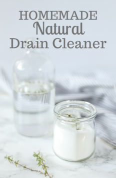 homemade drain cleaner ingredients on a marble countertop with a blue and white stripped towel in the background