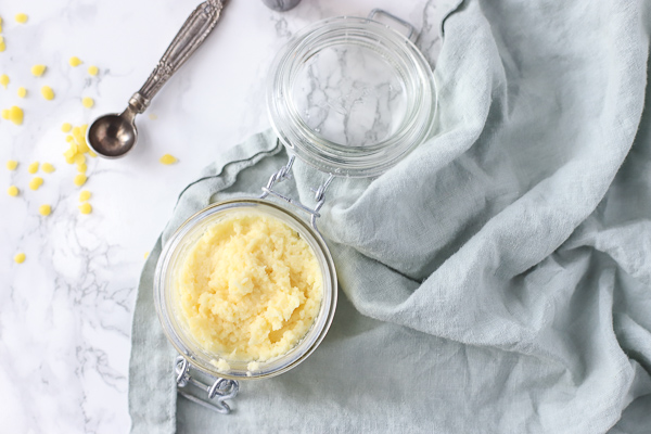 diy pomade in a glass dish on a blue napkin