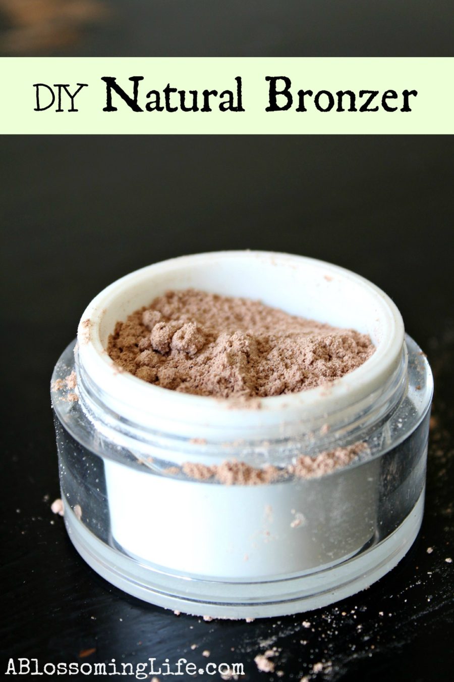 DIY Bronzer in a white and clear container on a black table