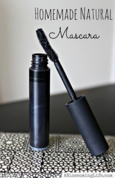 tube of natural homemade mascara on a black and white patterned plate