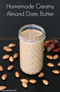 homemade almond butter in a mason jar with almond and dates spread around