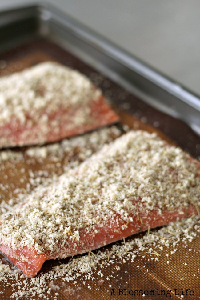 raw salmon with almond flour curst on a baking sheet