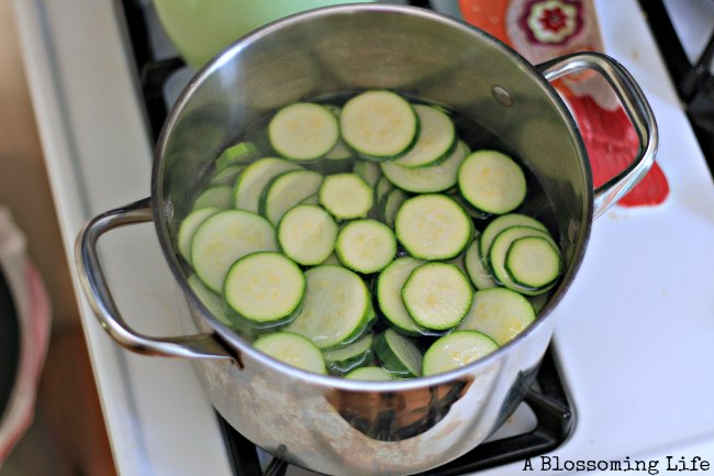 sliced zucchini in a pot of boiling water on a stove top