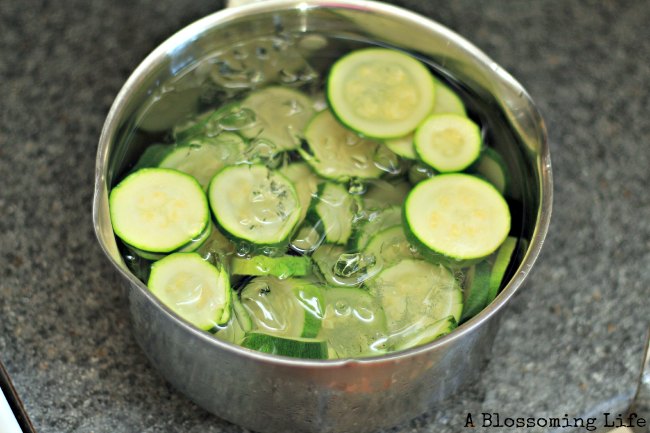 blanched zucchini in a pot of ice water