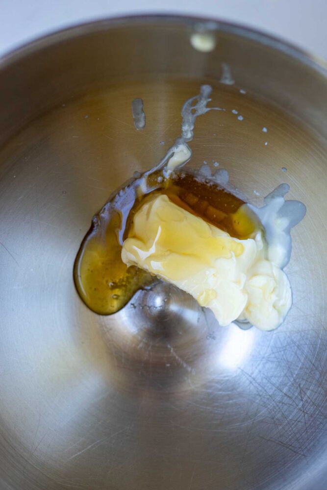 Honey and softened butter in a bowl of a stand mixer.