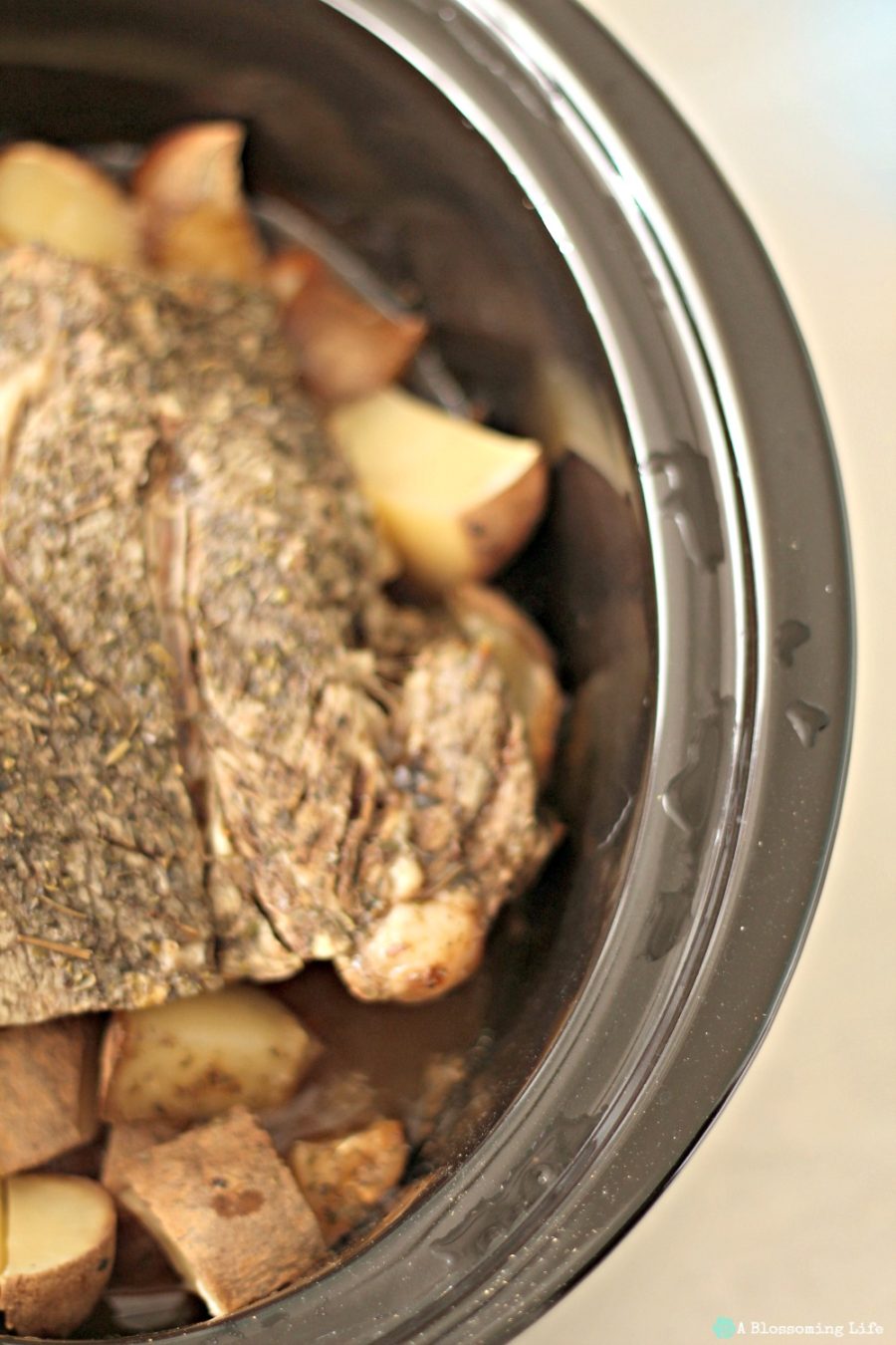 pot roast with carrots in potatoes in a slow cooker