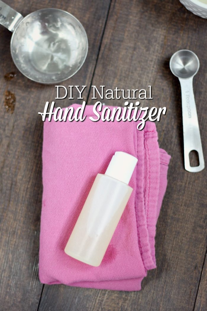 natural DIY hand sanitizer in a plastic container on top a pink napkin