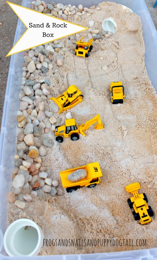 a plastic box with sand, rocks, and toy trucks for a fun fall activities for preschoolers