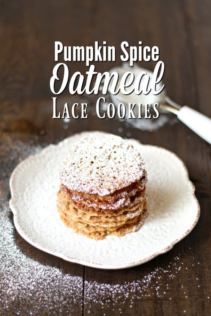 lace cookies on a cream plate topped with powdered sugar