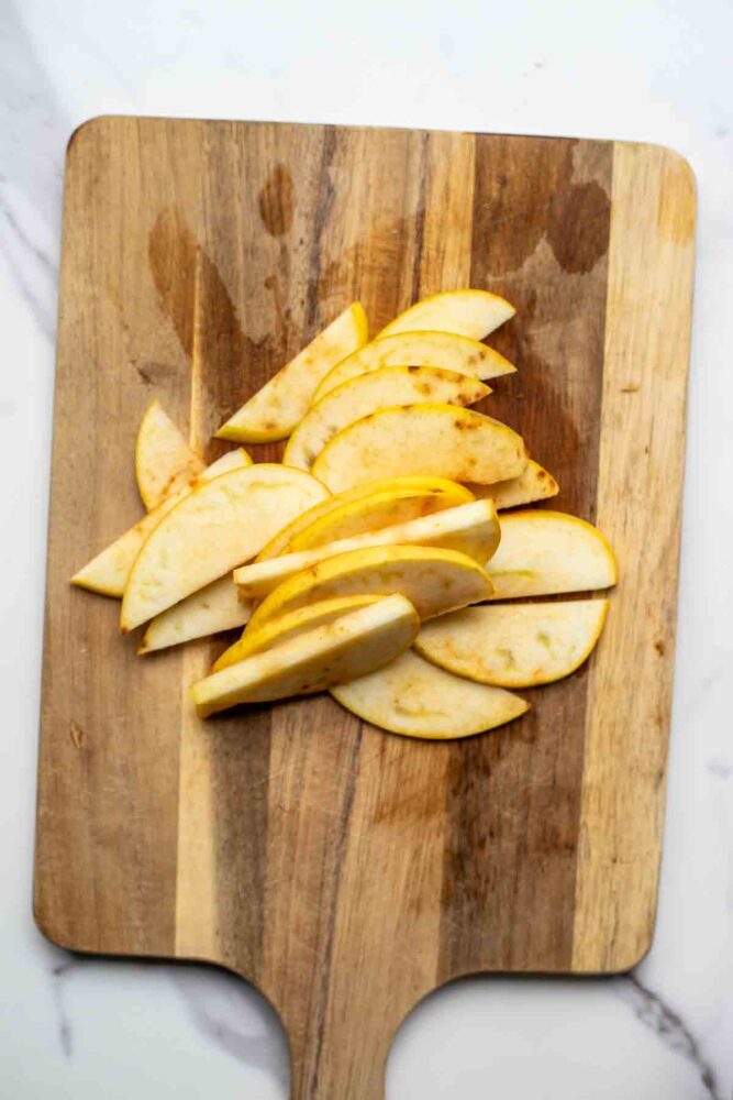 apples sliced on a cutting board.