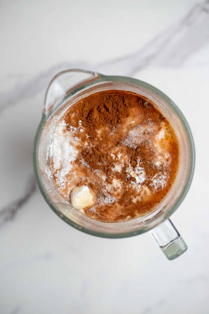 banana, milk, cinnamon, eggs and other ingredients in a blender.