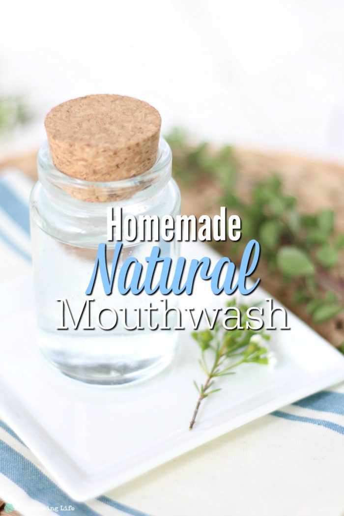 homemade mouthwash in a class jar on top a white plate with a flower