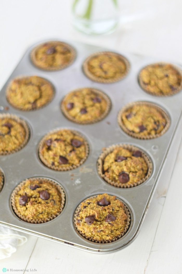 gluten free pumpkin muffins with chocolate chips in a muffin tin