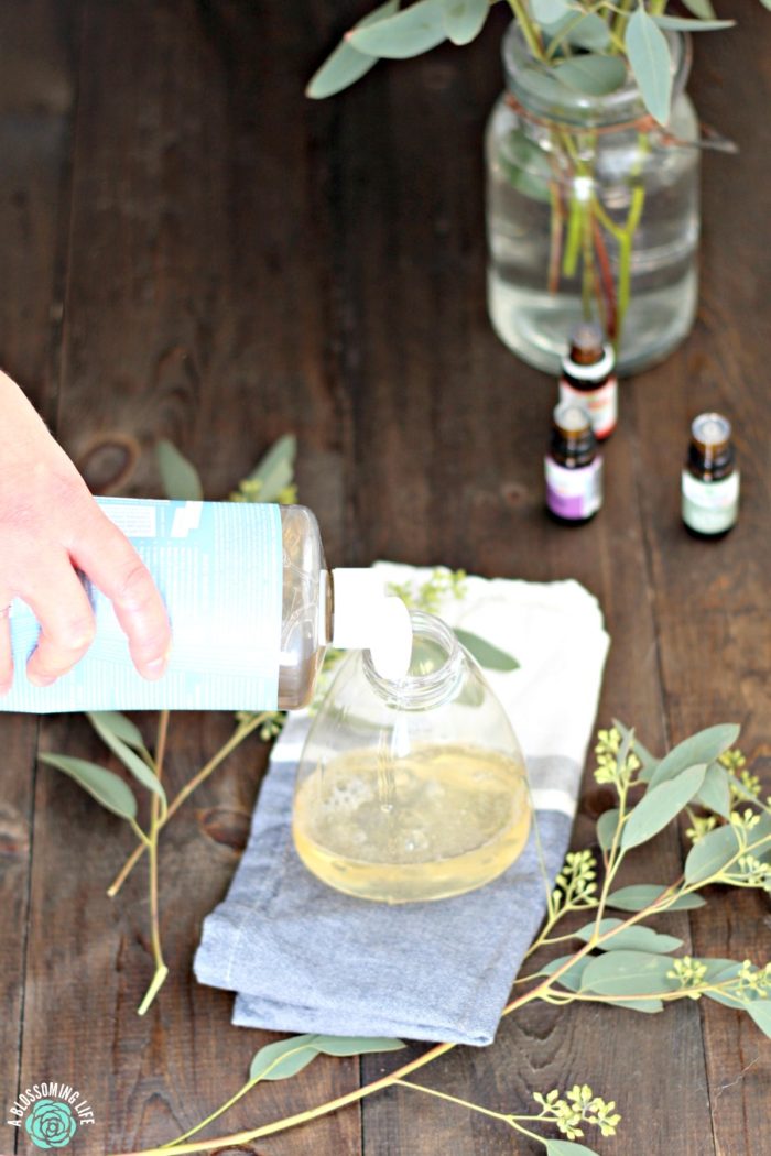 pouring Castile soap into soap bottle to make foaming hand soap