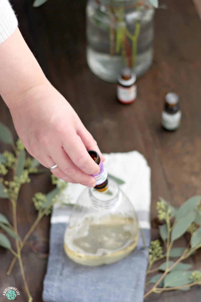 putting essential oils in castile soap to make foaming hand soap