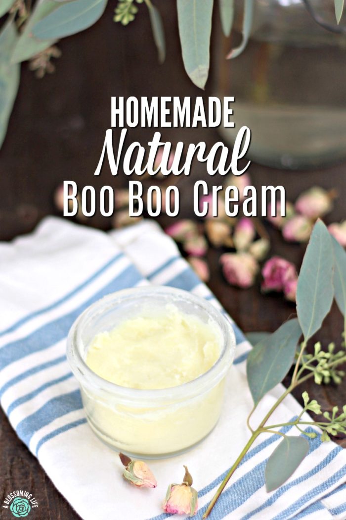 natural boo boo cream in a glass jar with eucalyptus around it