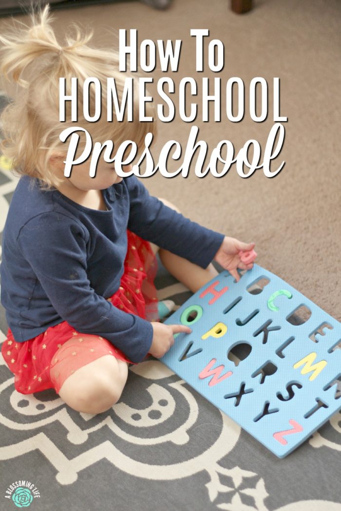 Child playing with letter mat for homeschool preschool lesson