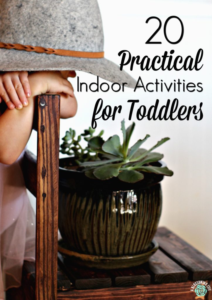 toddler wearing a had looking over a chair at a potted plant- indoor activities for toddlers