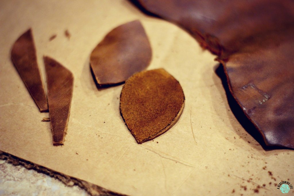 cutting out leather pieces for DIY leather earrings