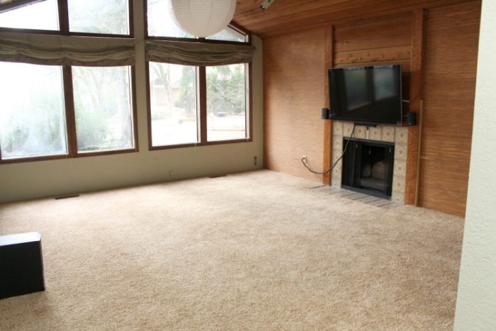 70's formal living room with dark walls and trim, and bamboo wallpaper