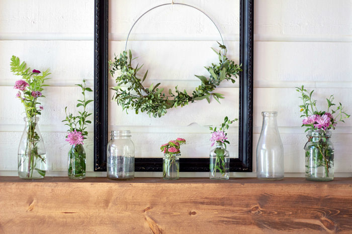 DIY Fireplace Mantel with stained wood on a white fireplace with shiplap