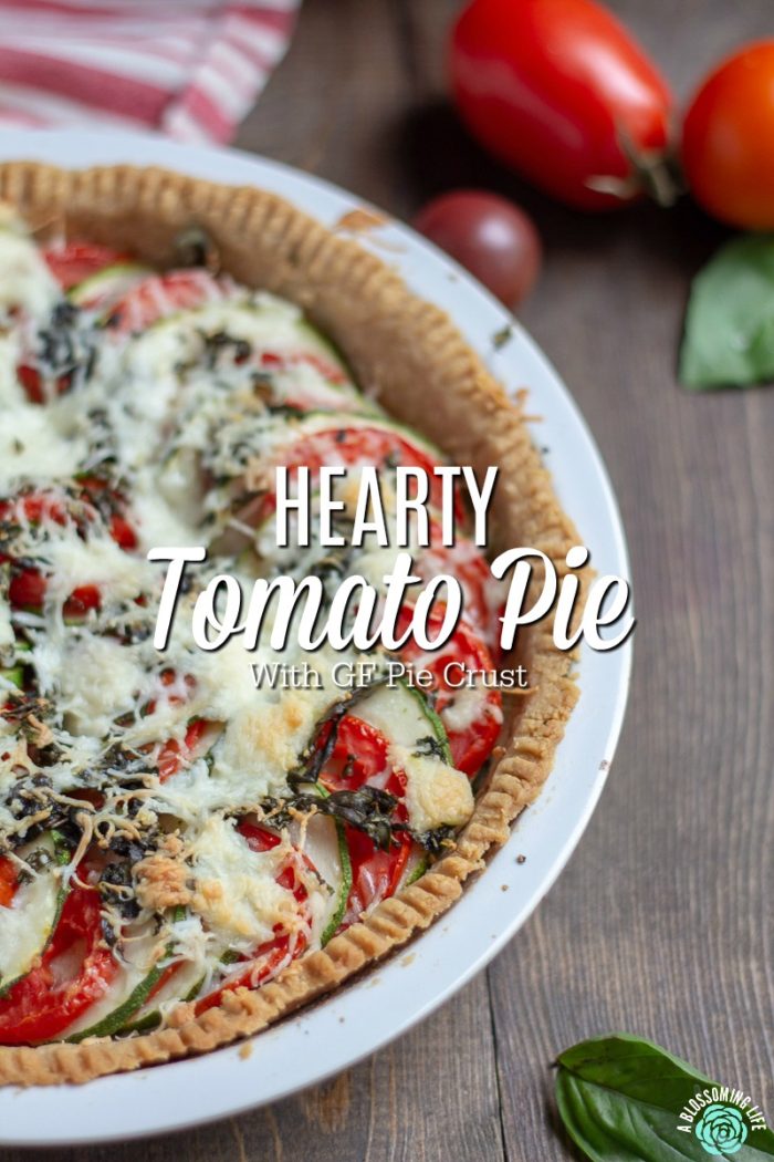 Tomato pie - This tomato pie recipe has a perfectly flaky and buttery pie crust that is loaded with tomatoes and zucchini and a touch of garlic and cheese to make this delicious savory pie. Great recipe for when your garden is beaming with fresh zucchini and tomatoes.