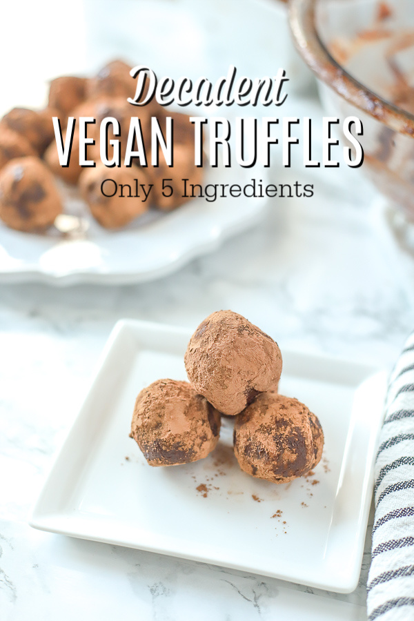 3 vegan truffles on a white square plate with a place of truffles behind it 