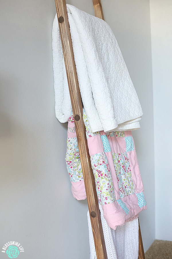 close up of a diy blanket ladder with blankets resting up against a wall