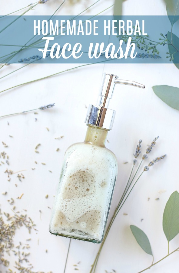 homemade face wash in a glass soap pump with dried lavender around the DIY face wash
