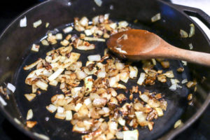 caramelizing onions in a cast iron skillet for spinach frittatas