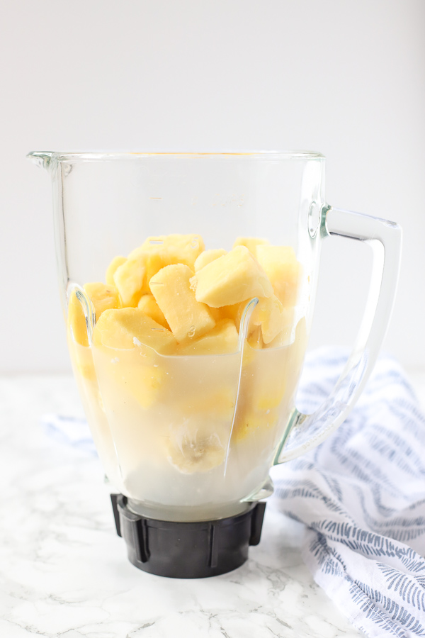 coconut milk, banana, and pineapple in a blender