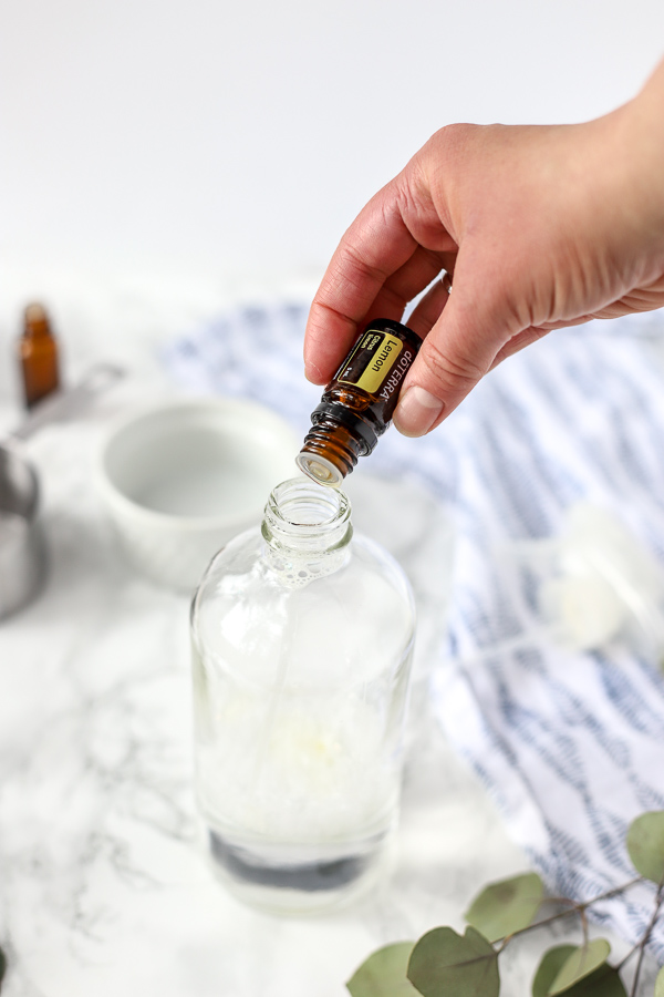 adding essential oils to glass bottle