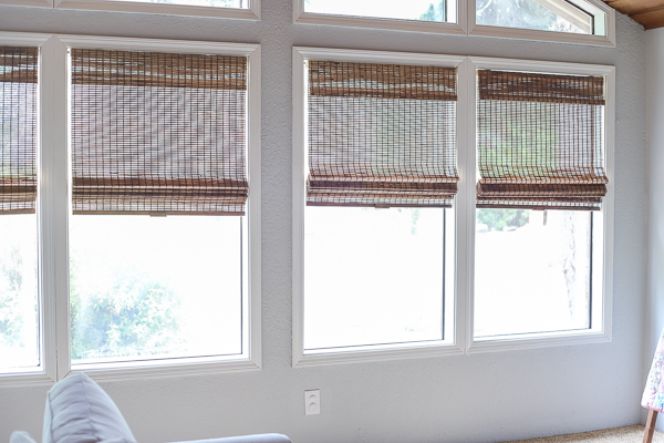 living room with painted trim and wood blinds