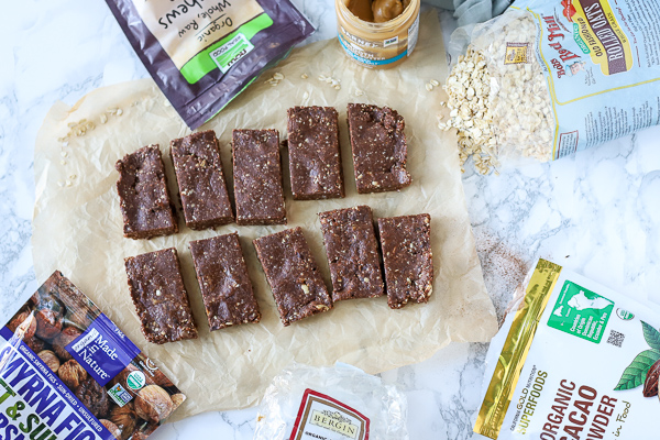 homemade energy bars sliced on parchment paper with ingredients arount it