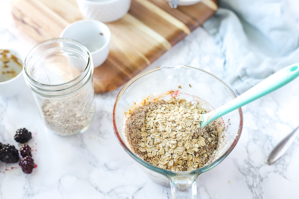 pyrex glass measuring cup filled with ingredients - adding oatmeal 