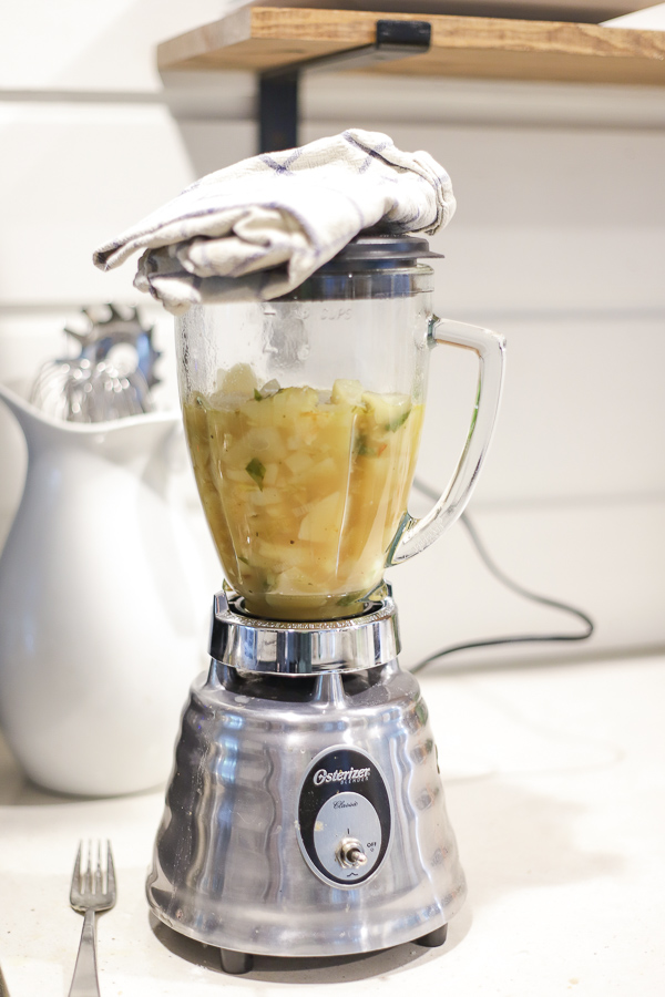 potato leek soup in a blender on a white countertop