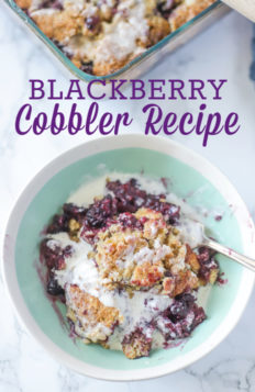 Blackberry cobbler topped with cream in a teal and cream bowl