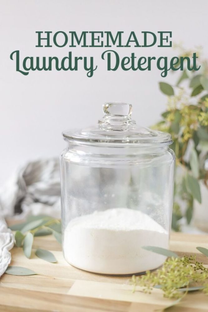 natural homemade laundry detergent on a wood counter with eucalyptus leaves spread around