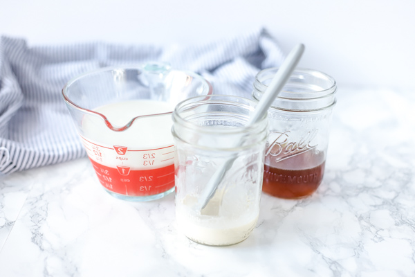 ingredients to make homemade sweetened condensed milk in jars