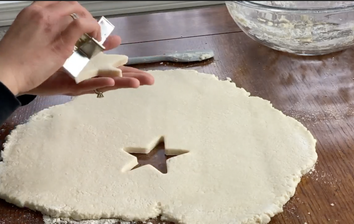 cutting out salt dough ornaments using a star cookie cutter