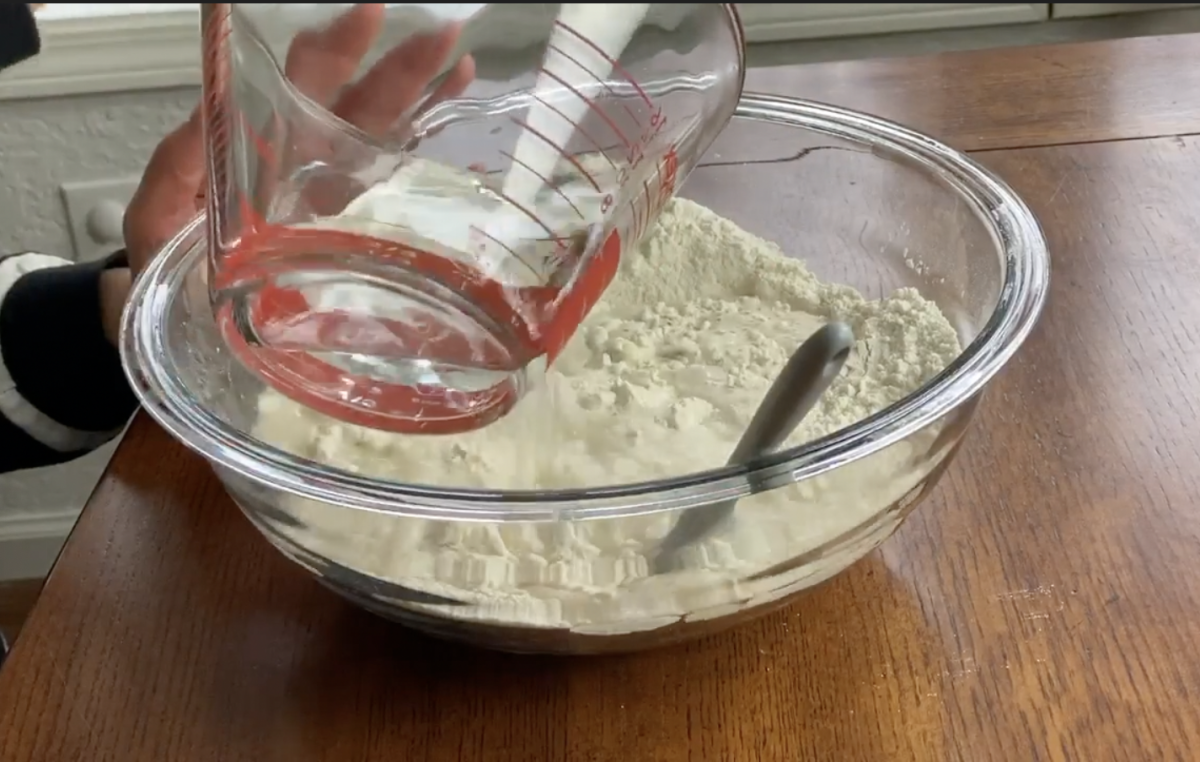 adding water to salt and flour to make salt dough