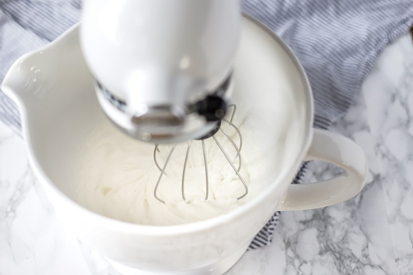 cream being whipped in a stand mixer