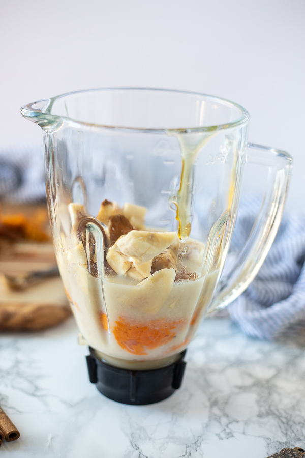 ingredients added to a blender to make a sweet potato smoothie