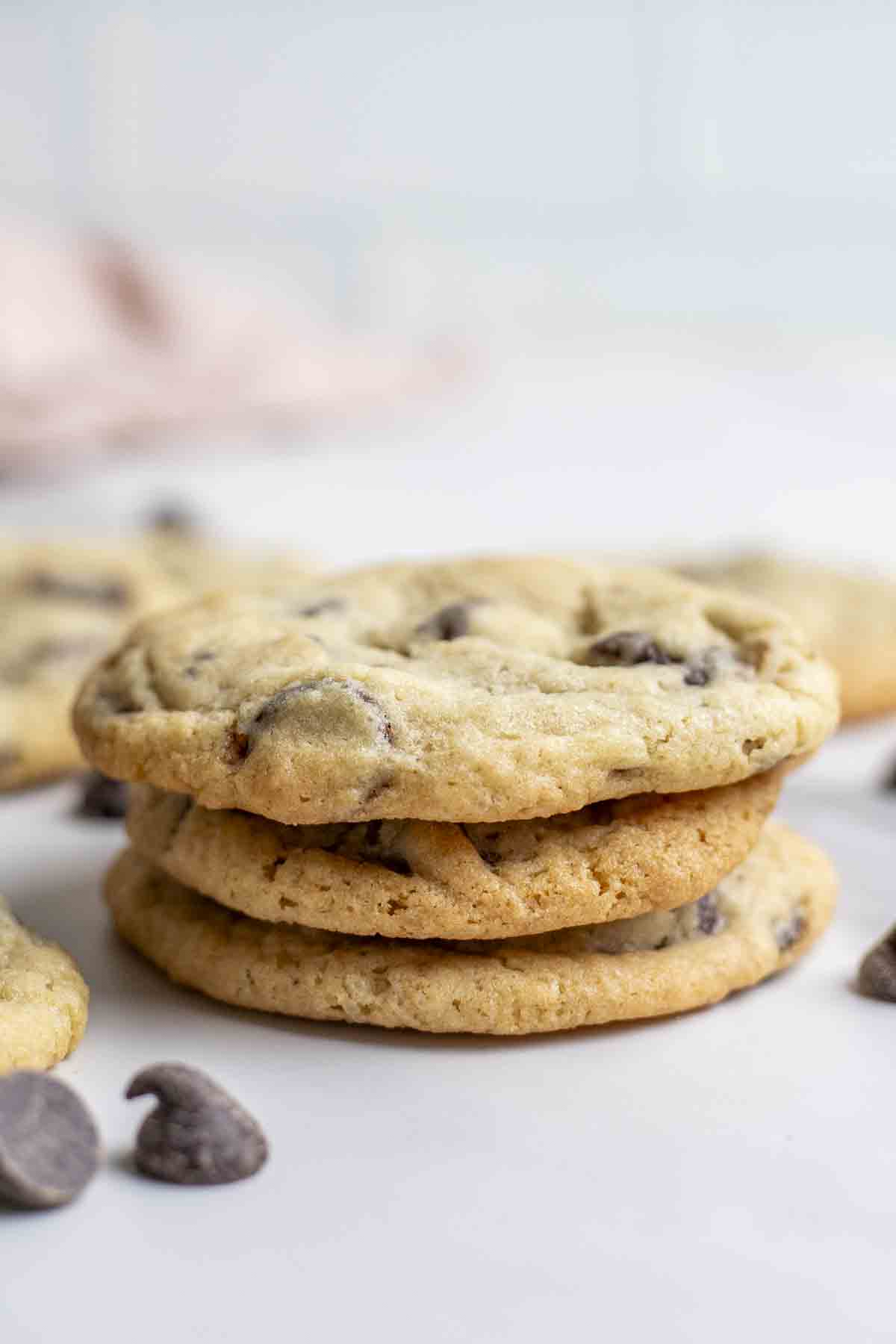 Three sourdough chocolate chip cookies stacked on top of each other.