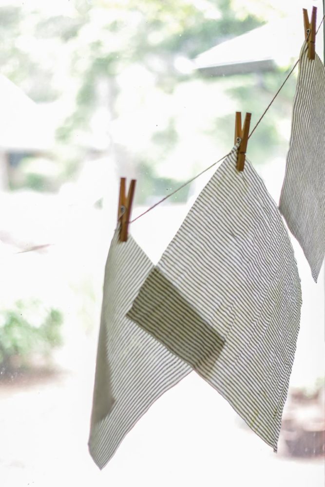 beeswax fabric hanging on twine with clothes hanger