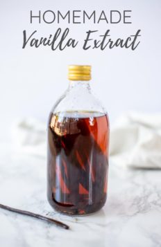 homemade vanilla extract in a bottle with a vanilla bean in front.
