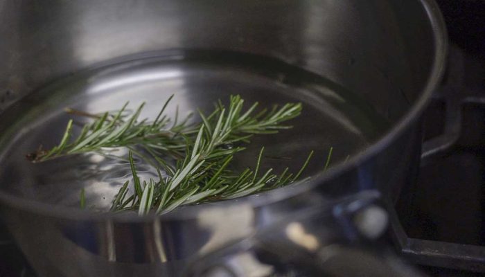 rosemary sprigs and water in a saucepan