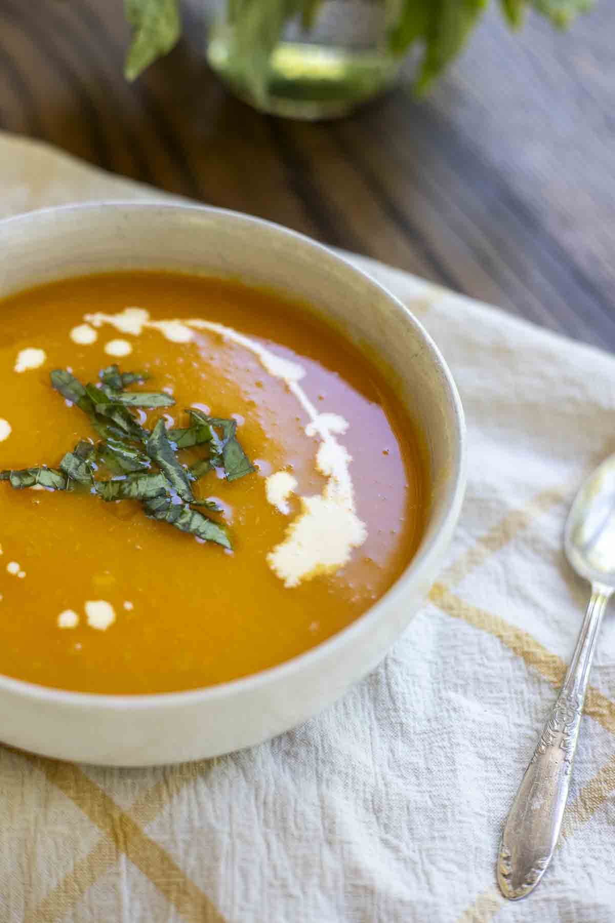 butternut squash soup topped with cream and fresh herbs.