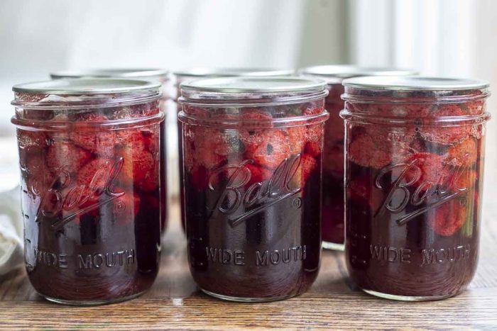 six jars of whole strawberries canned in syrup
